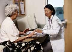 provider in front of computer talking to patient